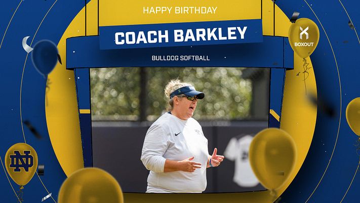 Happy Birthday template with navy and gold festive design featuring yellow balloons and confetti. Large photo frame for person image in center, with white banner for name at top and blue subtitle area below. Designed for video boards and sports celebrations.
