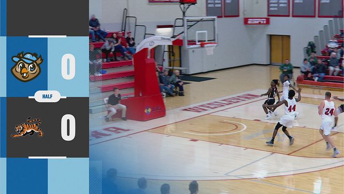 Score update template in landscape layout featuring an athlete holding a basketball, score areas on the left, team names, and branding elements in a dark and vibrant color palette.